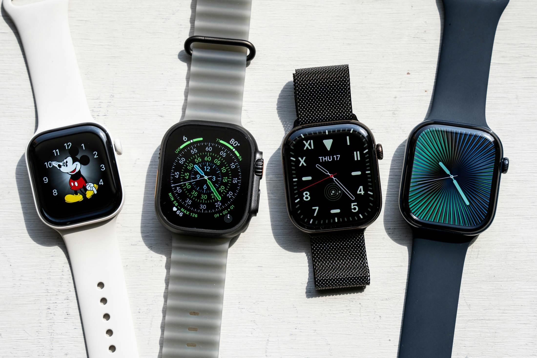 4 Apple Watches next to each other.
